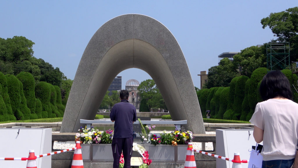 Zwei Japaner beten vor dem Friedensdenkmal.